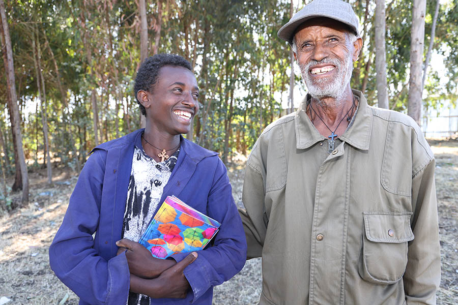 14-year-old Wogene, a class 7 student in Ethiopia’s Oromia region, and his adopted father, 80-year-old Hordofa.